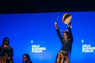 Three dancers from the Ugandan group Ghetto Kids jump perfectly together in the air during their stage performance at the Oslo Business Forum. Photo Credit: Triplets Ghetto Kids / Instagram