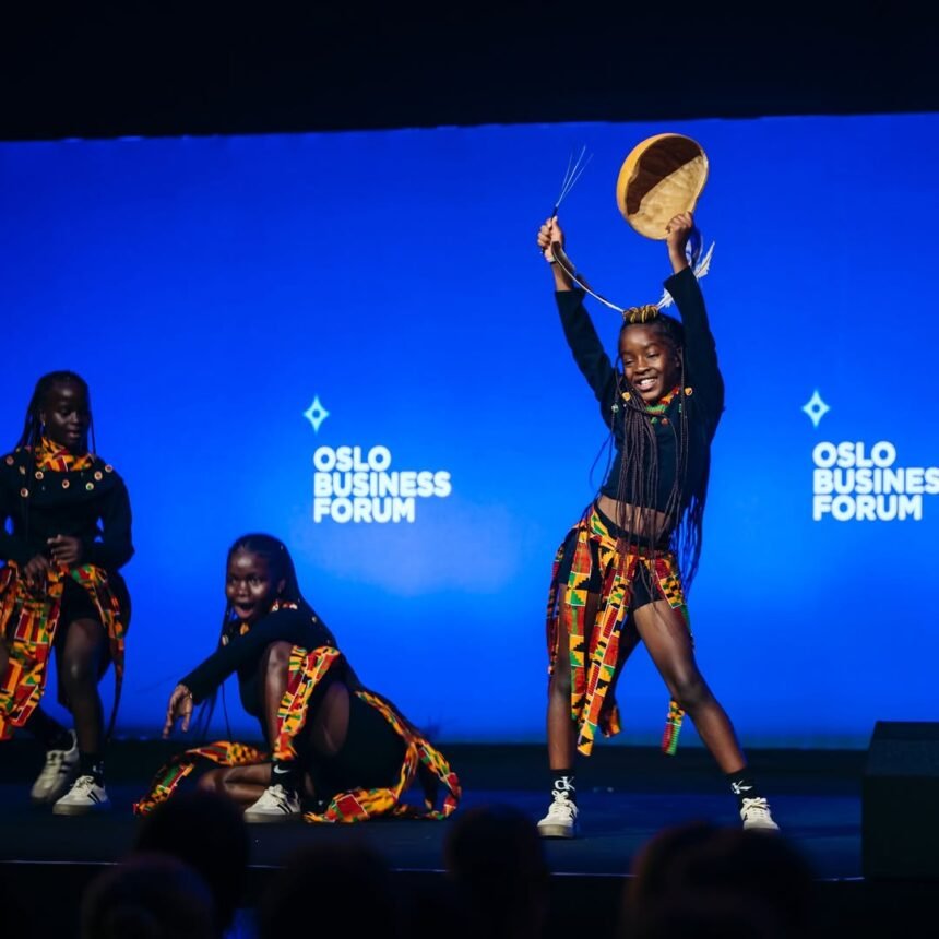 Three dancers from the Ugandan group Ghetto Kids jump perfectly together in the air during their stage performance at the Oslo Business Forum. Photo Credit: Triplets Ghetto Kids / Instagram