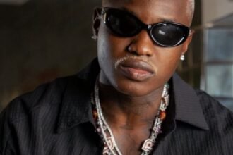 Afrobeats singer Ruger posing for a photo shoot