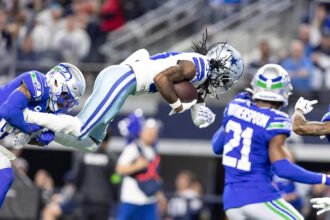 CeeDee Lamb of the Dallas Cowboys diving during a football game against the Seattle Seahawks