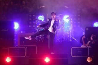 Phil Jamieson performing on stage before his tour cancellation