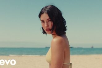 Gracie Abrams performing in her music video for I Love You, I'm Sorry