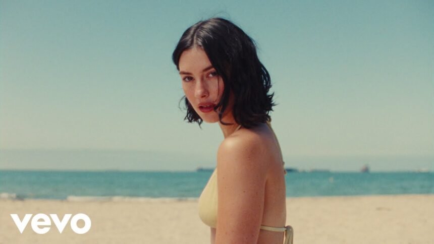 Gracie Abrams performing in her music video for I Love You, I'm Sorry