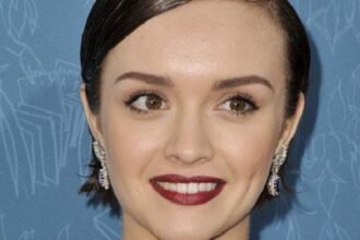 Actress Olivia Cooke smiling at a public event.
