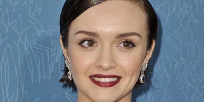 Actress Olivia Cooke smiling at a public event.