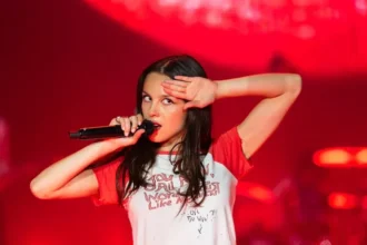 Olivia Rodrigo performing live on stage.