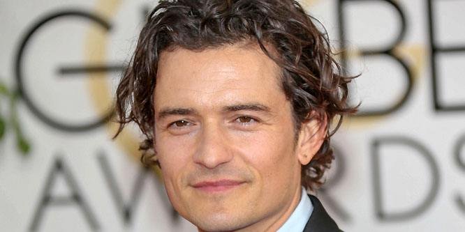Orlando Bloom looking directly at the camera in a stylish outfit