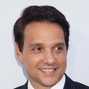 Ralph Macchio standing and smiling.