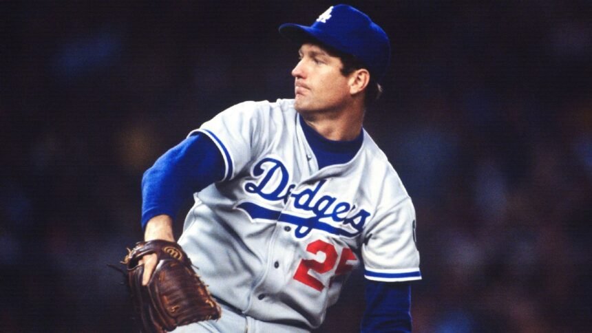 Former MLB pitcher Tommy John smiling during a baseball event