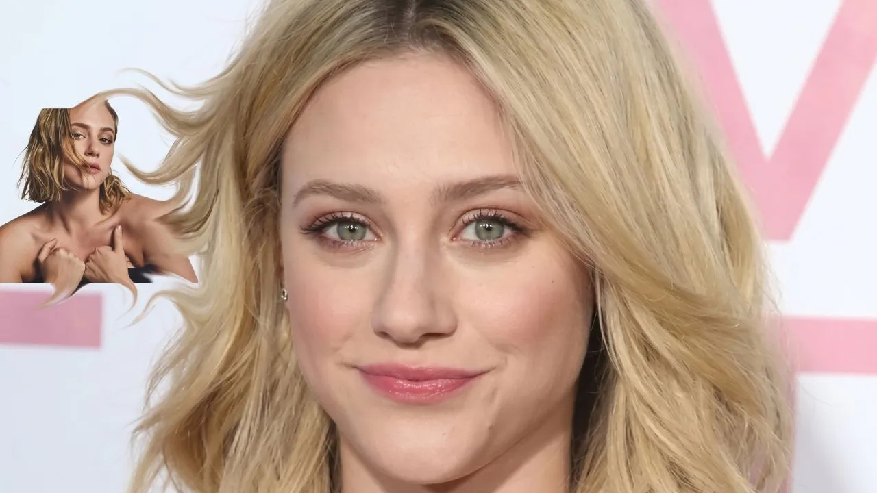 Lili Reinhart smiling on a red carpet, wearing a black dress with her hair styled in loose waves