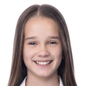 Alisha Weir, the Irish actress playing Matilda, smiling on set.