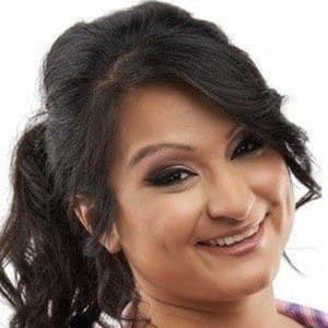 Aphmau (Jessica Bravura) sitting at a computer desk, wearing a headset, playing Minecraft on her YouTube channel.