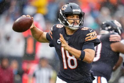 Caleb Williams on the Chicago Bears sideline, holding his right hamstring and being assisted by medical staff during the 9-3 loss to the Minnesota Vikings at Soldier Field.