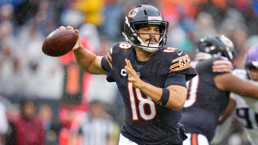 Caleb Williams on the Chicago Bears sideline, holding his right hamstring and being assisted by medical staff during the 9-3 loss to the Minnesota Vikings at Soldier Field.