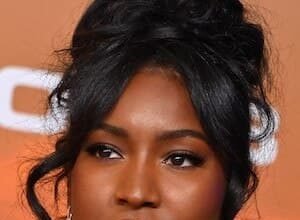 Carlacia Grant smiling while posing at a red carpet event.