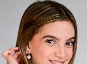 Chyler Emery, a young actress and singer, smiling on a film set.