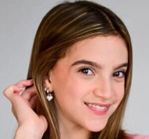 Chyler Emery, a young actress and singer, smiling on a film set.