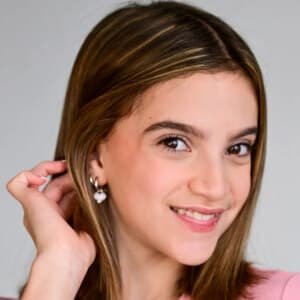 Chyler Emery, a young actress and singer, smiling on a film set.