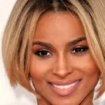 Ciara posing for a portrait photo in a stylish outfit