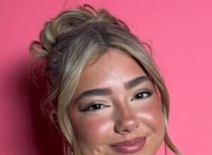Embreigh Courtlyn dancing in a TikTok video, wearing casual clothes and smiling.