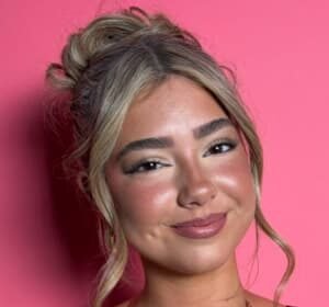 Embreigh Courtlyn dancing in a TikTok video, wearing casual clothes and smiling.
