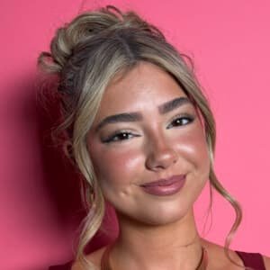 Embreigh Courtlyn dancing in a TikTok video, wearing casual clothes and smiling.