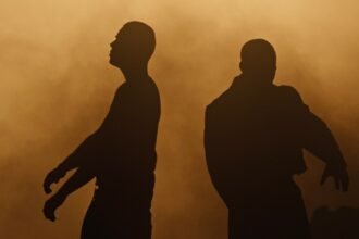 Screenshot of The Kid LAROI and GIVĒON performing in the official "GET EVEN" music video, showing the director's visual style.