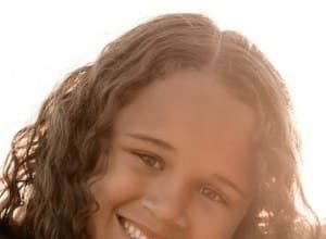 Hayden Fluellen posing happily for a family biography profile picture