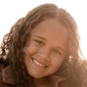 Hayden Fluellen posing happily for a family biography profile picture