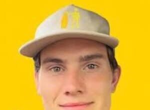 Portrait of Jesse Moncur, a young TikTok star, wearing a casual shirt and smiling while holding a phone