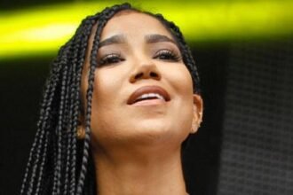 R&B singer Jhené Aiko posing for a picture.