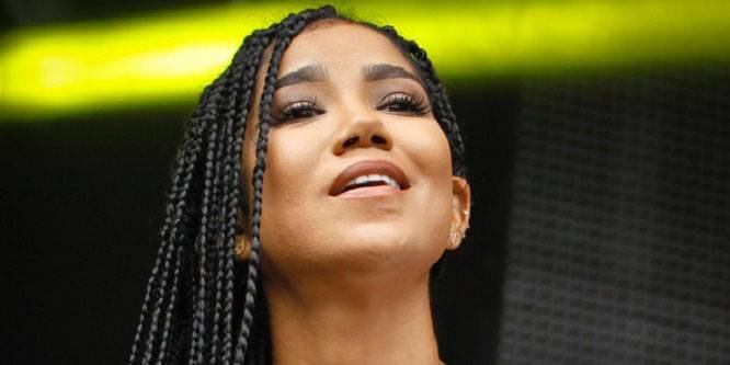R&B singer Jhené Aiko posing for a picture.