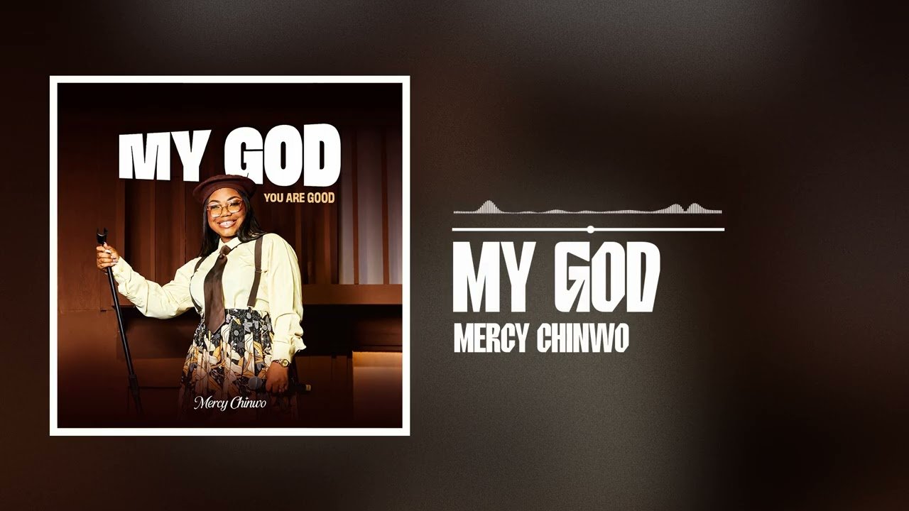 Mercy Chinwo singing the gospel song My God on stage with a microphone