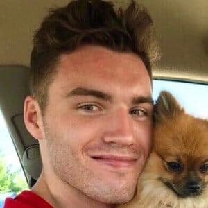 Nick Gallais smiling while holding his cat Bob during a TikTok video shoot