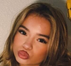 PresLee Faith, a teenage TikTok beauty influencer, smiling in a casual outfit during a video shoot in Dallas, Texas.