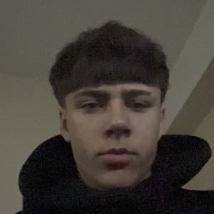 Portrait of richyidk, an 18‑year‑old TikTok creator from Talsi, Latvia, wearing a black hoodie while holding a phone.
