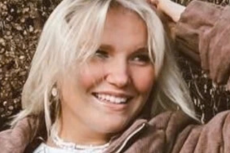 SaiDee Nelson smiling while filming a YouTube video for the Not Enough Nelsons family channel