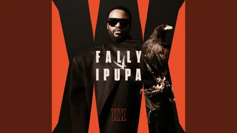 Fally Ipupa singing live, wearing a dark jacket, with stage lights behind him during his 2026 performance of Secret de Bakalos.