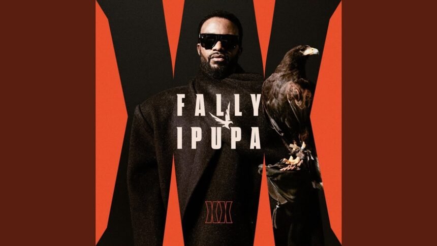 Fally Ipupa singing live, wearing a dark jacket, with stage lights behind him during his 2026 performance of Secret de Bakalos.