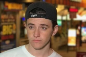Kyle Godfrey, known as Stromedy, a Canadian YouTube star, smiling in front of his channel logo
