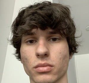 Portrait of Martin Andrijasevic, known as thatmartinkid, a Canadian TikTok comedian wearing a casual shirt and smiling