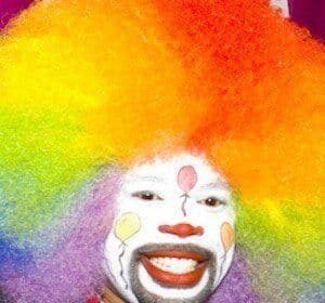 Thomas Johnson, known as Tommy the Clown, wearing a bright clown costume while dancing at a private party.