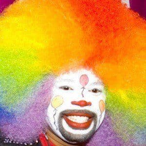 Thomas Johnson, known as Tommy the Clown, wearing a bright clown costume while dancing at a private party.