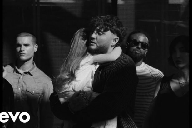 James Arthur performing in the official "Waste My Tears" video, surrounded by soft lighting and symbolic rain scenes