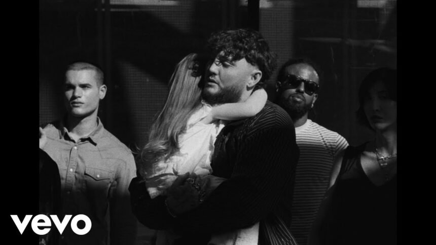 James Arthur performing in the official "Waste My Tears" video, surrounded by soft lighting and symbolic rain scenes