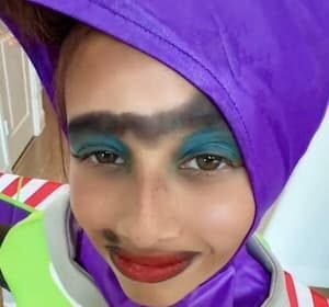 Portrait of yolandathetamalesqueen, a teenage TikTok creator from Florida, smiling while holding a plush Fugglers toy