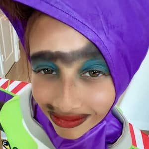 Portrait of yolandathetamalesqueen, a teenage TikTok creator from Florida, smiling while holding a plush Fugglers toy