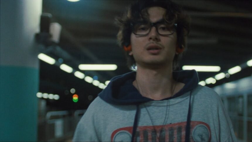 Fujii Kaze performing in the official "You" music video with bright lighting and dancers on set