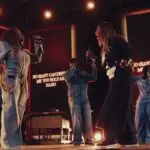 Tasha Cobbs Leonard and Le'Andria Johnson singing together on stage during a live recording