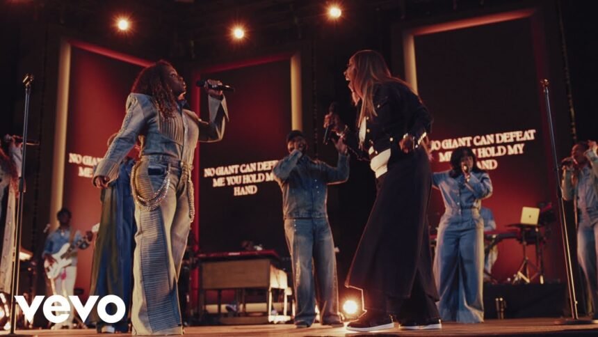 Tasha Cobbs Leonard and Le'Andria Johnson singing together on stage during a live recording